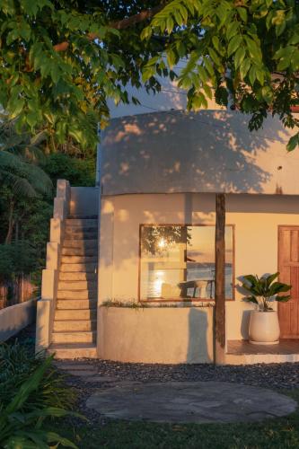 a small house with stairs leading to a window at Cabana - Boutique Beachfront Accommodation in Gili Islands