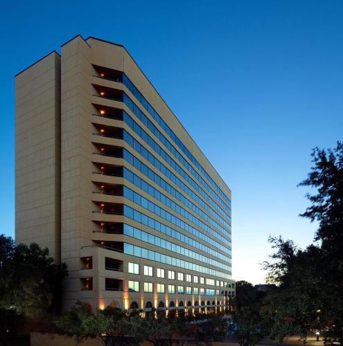 a tall white office building with a lot of windows at Austin Southpark Hotel in Austin