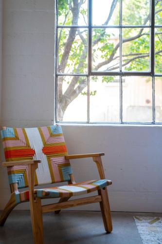 a wooden chair sitting in front of a window at The Myriad Hotel Louisville, Tapestry Collection by Hilton in Louisville