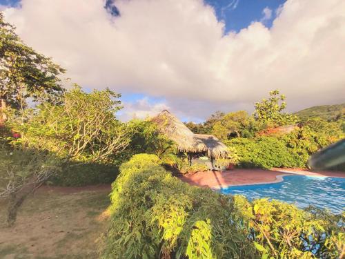 a view of a resort with a swimming pool at HUAHINE - Bungalow Napoleon in Fare