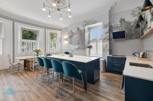 a kitchen with a table and chairs in a room at Huge spacious 8 bed luxury villa in Plymouth