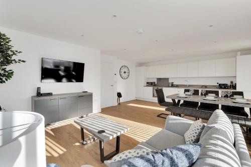 a living room with a couch and a table at The Pavilion by Pureserviced in Plymouth