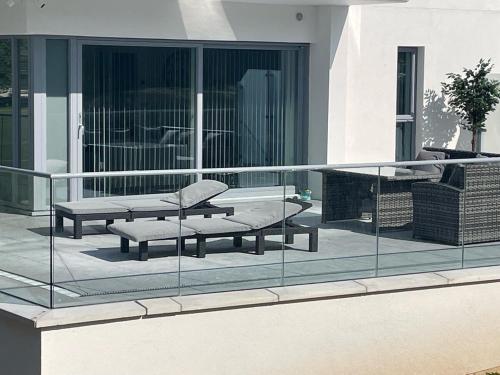 a balcony with two benches on a building at The Pavilion by Pureserviced in Plymouth