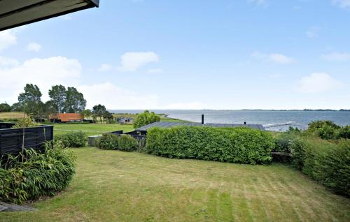 a yard with a view of the water at 3 Bedroom Nice Home In Faaborg in Fåborg