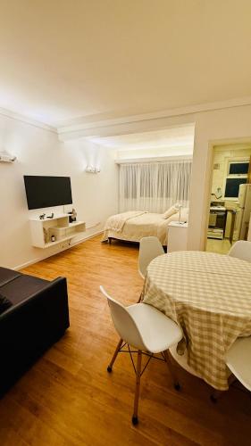 a room with a bed and a table and chairs at Ola MdP in Mar del Plata