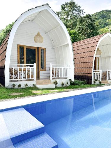 a white dome house with a swimming pool at Kelapa Lodge - Lombok - in Senggigi 