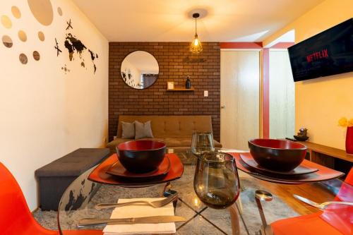 a living room with a glass table with two bowls on it at 10 minutes away from Zocalo in Mexico City