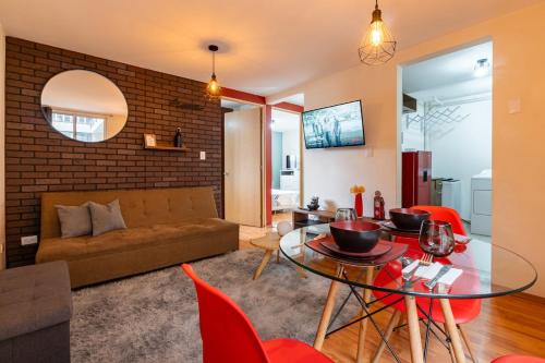 a living room with a couch and a glass table at 10 minutes away from Zocalo in Mexico City
