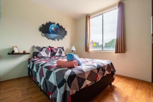 a bedroom with a bed with a colorful comforter at 10 minutes away from Zocalo in Mexico City