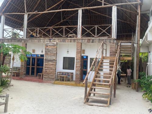 a building with a staircase in front of it at Zanzibar beach escape 1&2 in Bwejuu