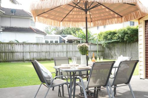 a table and chairs under an umbrella on a patio at The Clan Terrigal in Terrigal