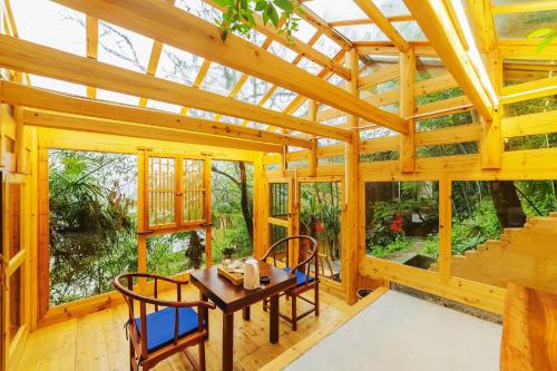a wooden dining room with a table and chairs at Dayong Antique Feature Resort in Zhangjiajie