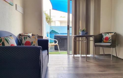 a living room with two chairs and a table at Oceanside Hawks Nest in Hawks Nest