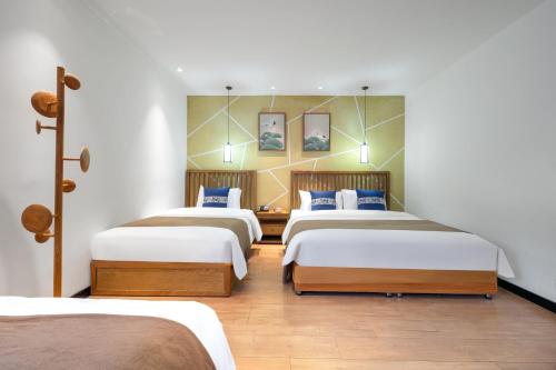 a group of four beds in a room at Beijing Tangfu Nanluoguxiang Tian an Men Lama Temple San Li Tun Snack Street Hotel,Free Laundry Dry Service and Free Afternoon Tea &professional Free Tour Ticket Service with English Speaking Staff in Beijing