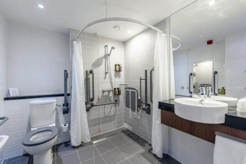 a bathroom with a toilet and a sink and a shower at Holiday Inn Express Aberdeen Airport by IHG in Dyce