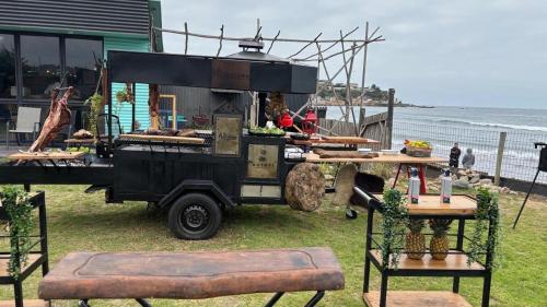 a food truck parked next to a table with food at Hotel Trocadero in Concón