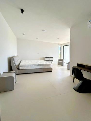 a large white room with a bed and a piano at Luxury Villa with Ocean Views ! Minimum booking 1 week in Cascavelle
