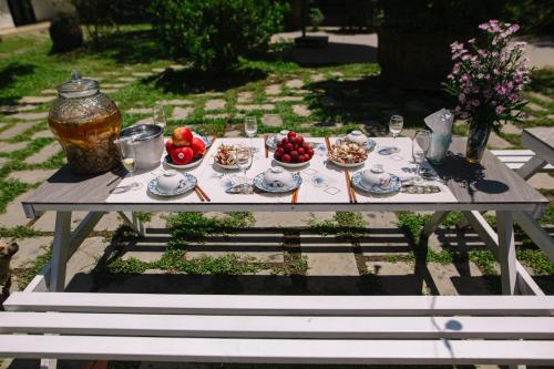 a picnic table with plates of food on it at Homestay PHƯỢNG HOÀNG in Hue