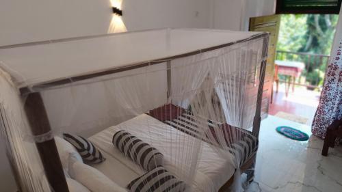 a bird cage with pillows in it at Forest Rawana homestay Ella in Ella