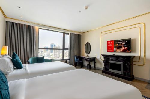 a hotel room with two beds and a fireplace at Dolce by Wyndham Hanoi Golden Lake in Hanoi