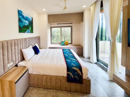 a bedroom with a king sized bed and a window at Monsoon Mist Kerala in Pīrmed