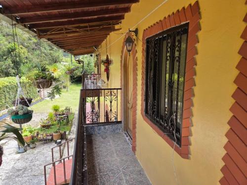 a balcony of a house with a black gate at Finca la Martina in Barbosa