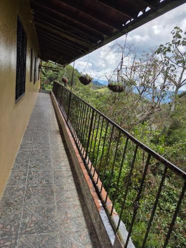 a balcony of a house with a fence at Finca la Martina in Barbosa