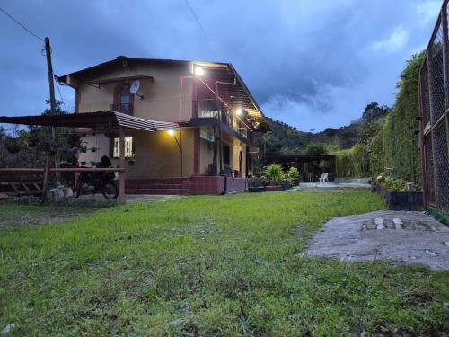 a house with lights on the side of it at Finca la Martina in Barbosa
