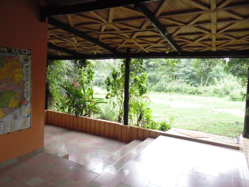 a room with a large window with a view of a garden at Wli Water Heights Hotel in Wli Afegame