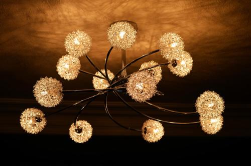 a chandelier with many lights hanging from a ceiling at Kintrae B&B in Buckie