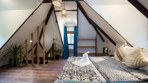a bedroom with a bed and a staircase at Manta House - Villa in Town in El Nido
