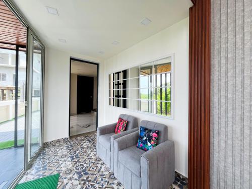 a living room with a couch and a window at Monsoon Mist Kerala in Pīrmed