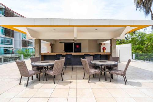 a patio with tables and chairs and a kitchen at Apt in Nuevo Vallarta, 5 min from beach in Nuevo Vallarta 