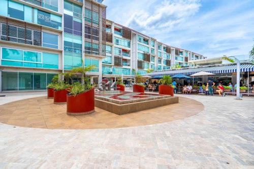 a building with a fountain in the middle of a courtyard at Apt in Nuevo Vallarta, 5 min from beach in Nuevo Vallarta 