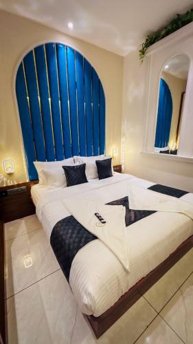 a bedroom with a large bed with a large window at Hotel Ocean Residency Thane West in Thane