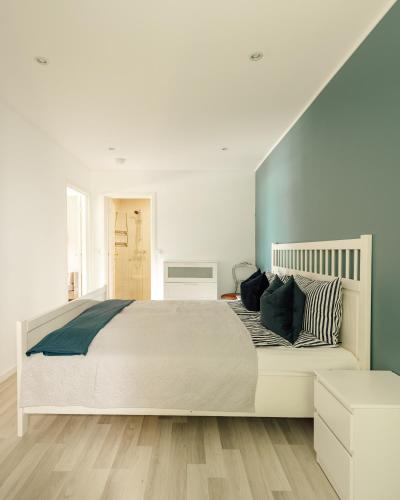 a bedroom with a large white bed with pillows at Vestre apartment in Ålesund