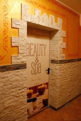 a door to a beauty and spa sign on a wall at Impero Hotel Beauty & Spa - Bike Hotel in Cantello
