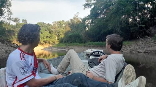two people sitting in a boat on a river at Amazon eagle Explore in Nauta
