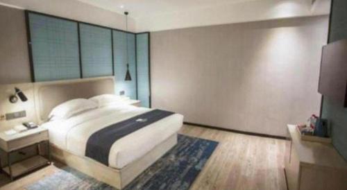 Ένα ή περισσότερα κρεβάτια σε δωμάτιο στο Echarm Hotel Jianshui Gucheng