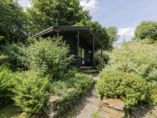 a log cabin in the middle of a garden at Buttermere in Ulverston