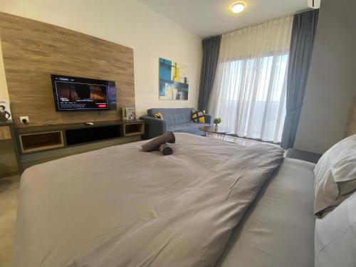 a bedroom with a large bed with a teddy bear on it at Imperio Residence Melaka by Jeffery Lam Home Management in Melaka