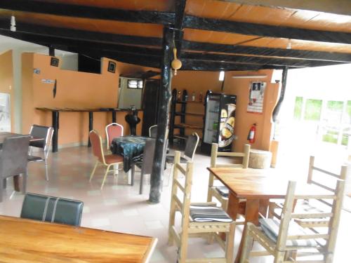 a dining room with wooden tables and chairs at Wli Water Heights Hotel in Wli Afegame