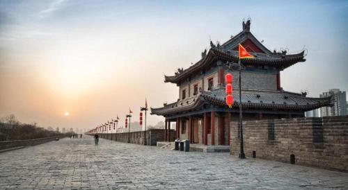a building with a sign on it on a street at City 118 Selected Hotel Xi'an Fengcheng Nan Road in Xi'an