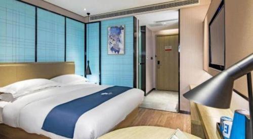 Ένα ή περισσότερα κρεβάτια σε δωμάτιο στο Echarm Hotel Guilin Railway Station the MixC