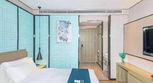 Ένα ή περισσότερα κρεβάτια σε δωμάτιο στο Echarm Hotel Guilin Railway Station the MixC