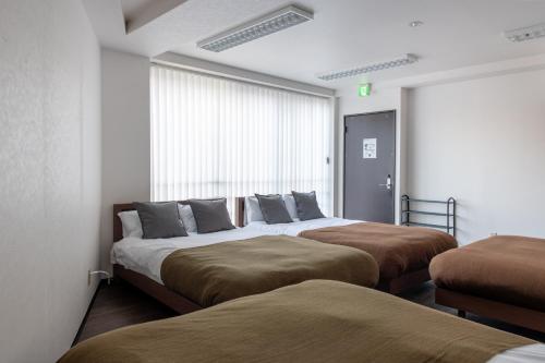 Ένα ή περισσότερα κρεβάτια σε δωμάτιο στο Tomihisa House