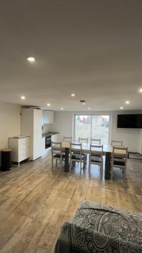 a living room with a dining room table and chairs at Hébergement curgy in Curgy