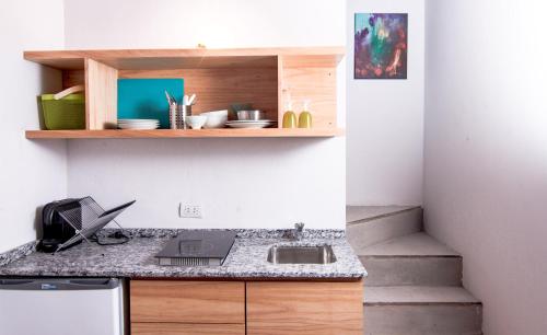 a kitchen with a counter with a laptop on it at Marcel de Buenos Aires in Buenos Aires