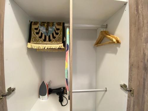 a bathroom with a closet with a shelf and scissors at Imperio Residence Melaka by Jeffery Lam Home Management in Melaka