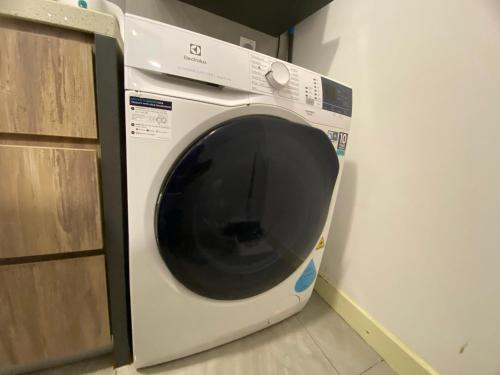 a white washing machine sitting in a room at Imperio Residence Melaka by Jeffery Lam Home Management in Melaka